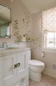 A feminine bathroom featuring soft pink and creamy tones