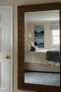 A bedroom interior design with white bedding and blue accents